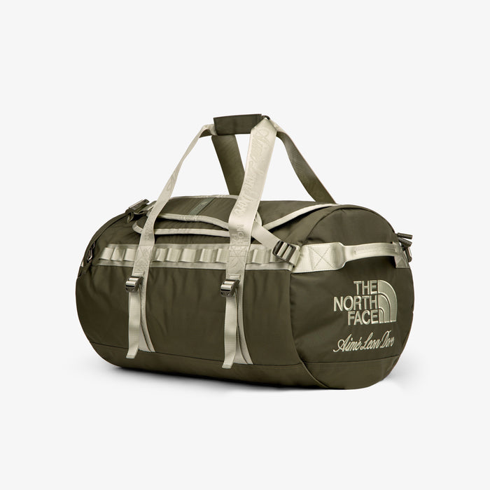 ALD / The North Face Base Camp Duffel in olive green with beige straps and logo, shown on a white background.