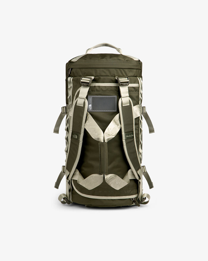ALD / The North Face Base Camp Duffel in olive green and beige, shown from the back with straps and mesh panel.