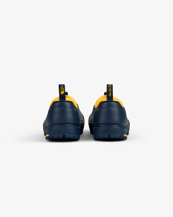 ALD / The North Face Base Camp Mule in navy with yellow trim, rear view, on a plain white background.