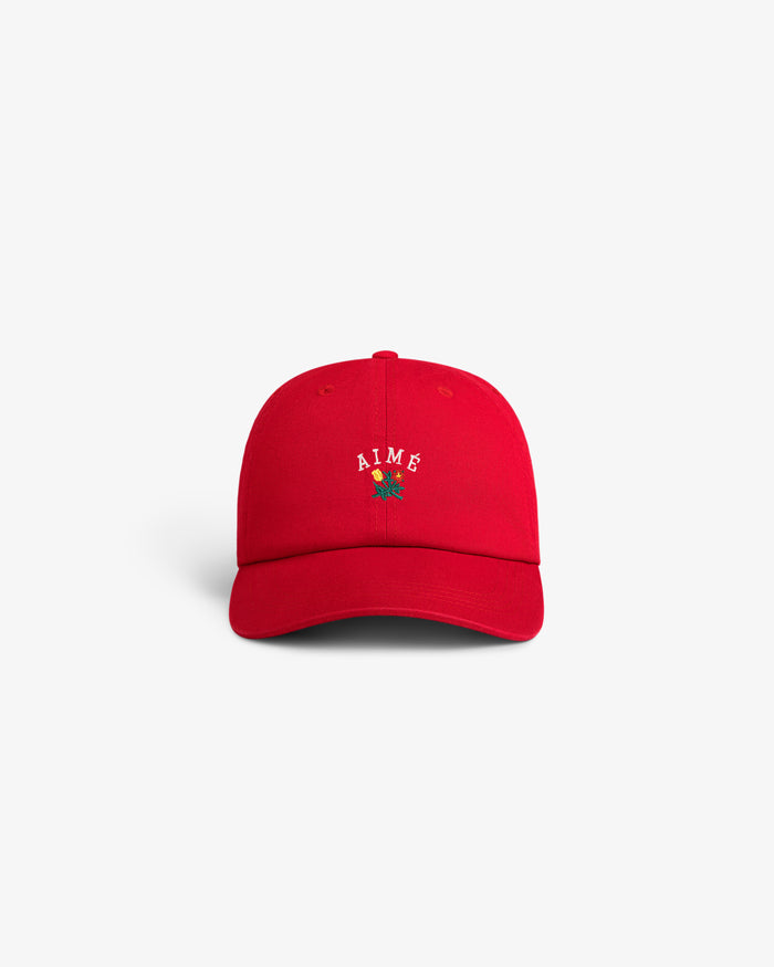 Crest Logo Hat with AIME and a small embroidered rose on the front, shown on a plain white background.