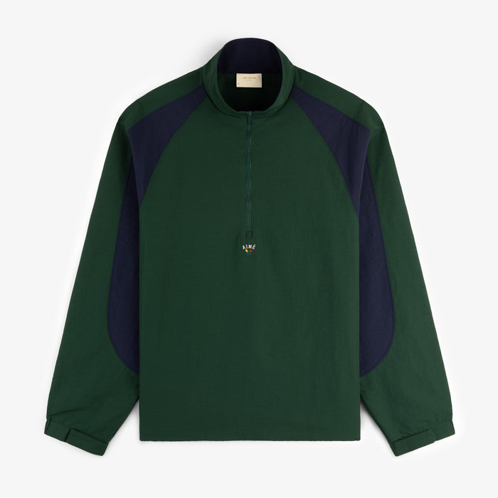 A dark green and navy Crest Nylon Half-Zip Pullover with beaded zipper pull, laid flat on a white background.