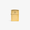 A Graphic Zippo Lighter with a gold finish and floral engraving, upright on a plain white background.