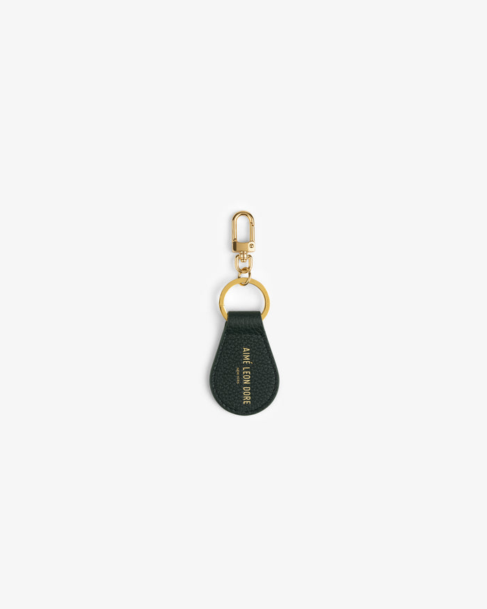Dark green Leather Key Fob with gold hardware and embossed gold text on a white background.