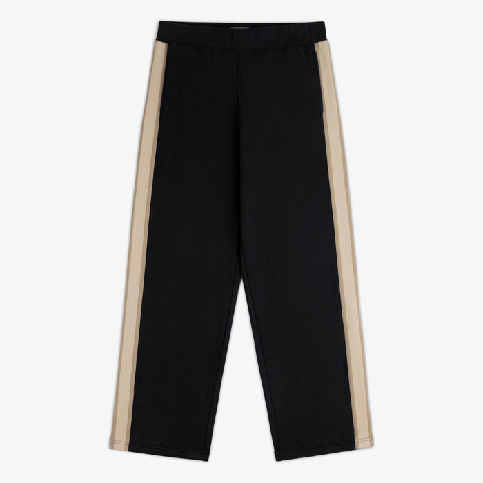 Saint George Track Pant in black with wide legs and beige side stripes, laid flat on a white background.
