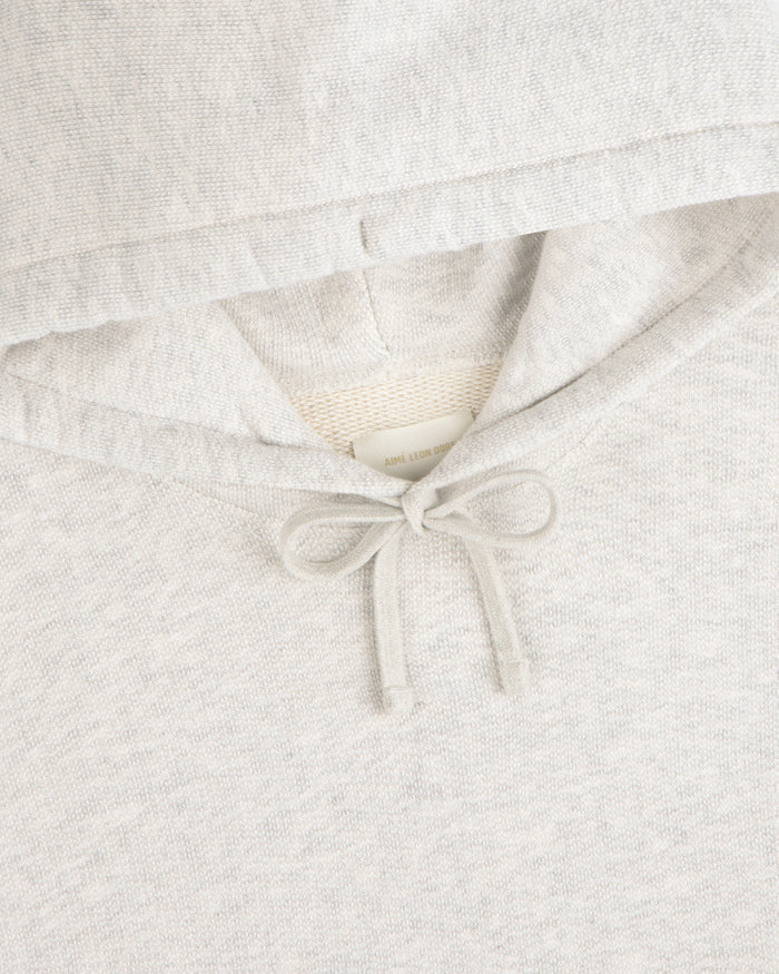 Close-up of the Stone Washed Marina Hoodie, featuring a bow-tied drawstring beneath the light gray hood.