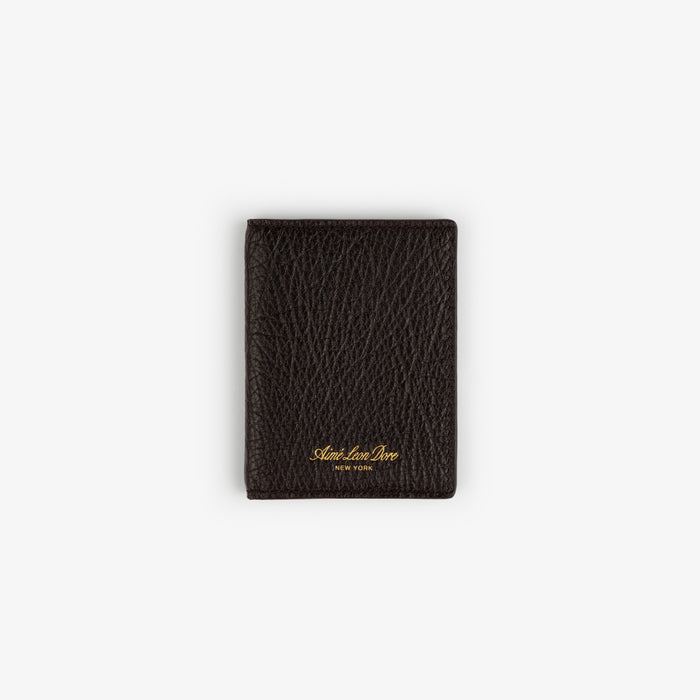The Tumbled Leather Bi-Fold Wallet is black with gold Aimé Leon Dore NEW YORK embossing and a textured finish.