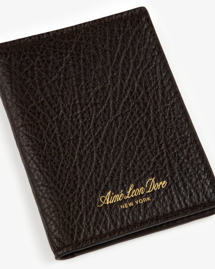 Tumbled Leather Bi-Fold Wallet in black with gold Aimé Leon Dore NEW YORK embossing on the textured front.