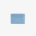 Tumbled Leather Card Holder in light blue with two slots and gold embossed text, shown on a white background.