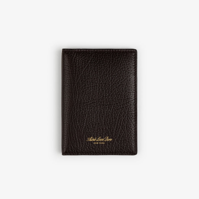 A closed black Tumbled Leather Passport Holder with gold text, resting on a plain white background.