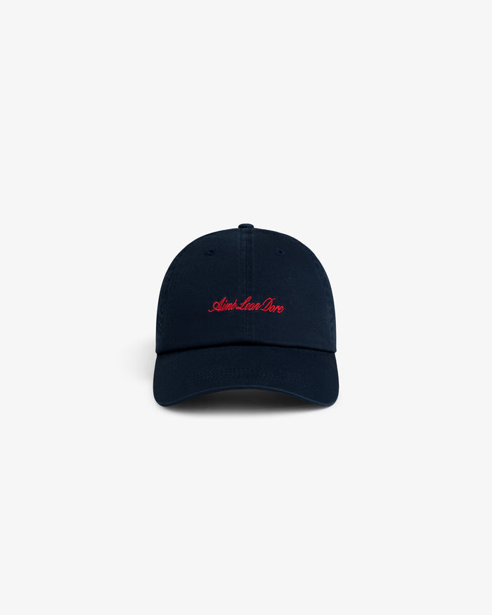 Washed Script Chino Hat: navy blue cap with red Aime Leon Dore cursive embroidery on the front, white background.