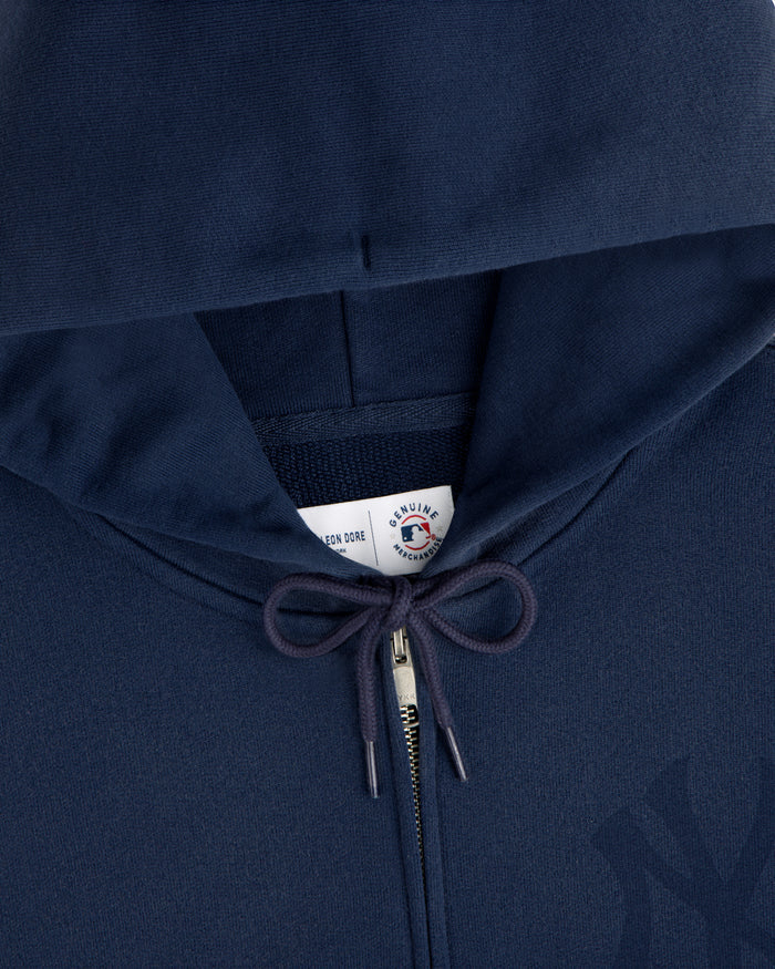 Close-up of a Yankees Washed Full-Zip Hoodie in navy blue, featuring drawstrings and a visible label inside the hood.