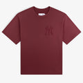 Yankees Washed Logo Tee: Burgundy short-sleeve shirt with a subtle Yankees logo on the left chest.